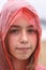 Portrait of pretty teenager girl in wet red raincoat under rain