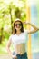 Portrait of pretty woman in sunglasses and hat over color background