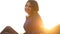 Portrait of pretty young brunette smiles woman at sunset in the field