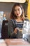 Portrait of Pretty young female barista smile to camera at coffee shop