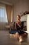 Portrait of a professional ballet dancer sitting on the wooden floor. Female ballerina having a rest.