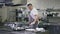 Portrait of professional chef in cook hat and apron adding sugar in cooking pan turning pineapple slice. Concentrated