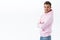 Portrait of professional, confident and enthusiastic blond stylish man in pink hoodie, standing profile and turn to