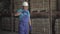 Portrait of professional employee adjusting white safety helmet and leaving factory storage. Adult confident Caucasian