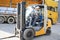 Portrait of professional forklift driver in factory's warehouse