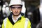 Portrait of Professional Heavy Industry Engineer or Worker Wearing Safety Uniform, Goggles and Hard Hat Looks at Camera
