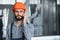 Portrait of Professional Heavy Industry Engineer Worker Wearing Safety Uniform, Hard Hat Smiling. In the Background