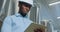 Portrait of a professional industrial engineer. Technician engineer in a safety helmet with a tablet. Large industrial