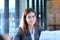 Portrait of an professional investment advisor businesswoman sitting in front of laptop at her desk while looking at camera and