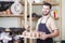 Portrait of Professional Male Ceramist Holding Tray with Clay Cups