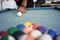 A portrait of a professional player with a blurry billiard ball foreground