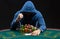 Portrait of a professional poker player sitting at pokers table