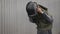 Portrait of the professional sand blasting worker takes off his hardhat and overalls after work and looking at camera with smile