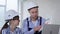 portrait of professional workers man and woman in protective helmets and color sample in their hands discuss design of