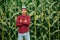 Portrait of a proud african american farmer standing with arms crossed with corn field in background.