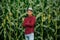 Portrait of a proud african american farmer standing with arms crossed with corn field in background