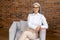 Portrait of proud and professional gray-haired mature business woman in stylish glasses and casual wear sitting in loft