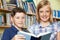 Portrait Of Pupils Reading Book In Library