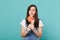 Portrait of puzzled displeased young woman in denim clothes hold, looking on colorful round lollipop isolated on blue