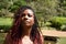 A portrait of a radiant and spectacular woman of color with a rare, braided hair style of red dye at the ends