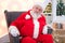 Portrait real authentic Christmas Santa Claus sitting in Shopping Mall.