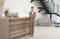 Portrait of receptionist near desk in hotel