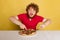 Portrait of red- bearded man getting ready to eat delicious Italian pizza isolated on yellow studio background.