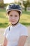 Portrait of a red-haired 11-year-old girl in a bicycle helmet. Girl athlete in a protective helmet on his head