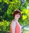 Portrait of a red-haired happy girl in park