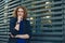 Portrait of red haired man over urban futuristic background