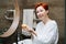 Portrait of a red haired mature woman washing her hands with a round soap block