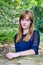 Portrait of red-haired teenage girl in forest