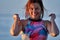 Portrait of a red-haired wet laughing woman of middle age in a swimsuit on a summer evening in the light of the setting sun.