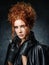Portrait of red-haired woman in a leather jacket on a dark background