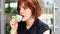 Portrait of a red-haired woman who drinks coffee