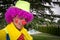 Portrait of the red nose clown with green hat and big red tie