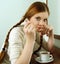 Portrait of redhead girl drinking hot coffee