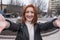 Portrait of a redhead woman with grunge style who takes a selfie.