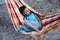 Portrait of relax young boy lying in hammock in summer vacation