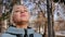 Portrait of a relaxed woman breathing deeply in a spring city park.