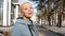 Portrait of a relaxed woman breathing deeply in a spring city park.