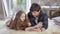 Portrait of relaxed young man and little girl using tablet and talking. Caucasian single father and daughter resting at