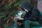 Portrait of relaxing teenager looking at skateboard in his hands