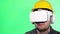 Portrait of a repairman using virtual reality glasses. Place for advertising on a chromakey