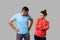 Portrait of resentful dissatisfied couple in casual wear standing together. isolated on gray background