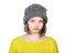 Portrait of resentful teenager in funny hat knitted jumper and b