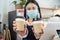 Portrait of restaurant waiter wear mask handing cup of coffee in cafe. Happy Attractive beautiful woman worker work in coffeehouse