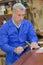 Portrait retired carpenter sitting at workshop