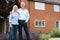 Portrait Of Retired Couple Standing Outside Home