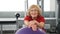 Portrait of retired pleasant woman on fitness ball in gym. Healthy and active old woman. Active seniors. Old lady in